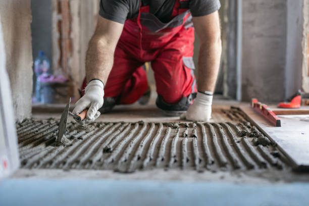 Using a masonry bit to prepare surface for tile and floor installation in NYC home.