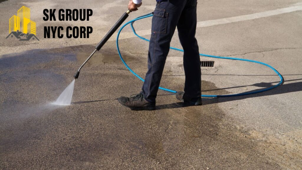 Power washing service cleaning asphalt driveway with high-pressure water by SK Group NYC Corp in NYC