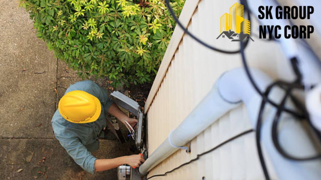 Worker in yellow hard hat fixing gutter leak on residential house exterior to improve drainage and prevent water damage.