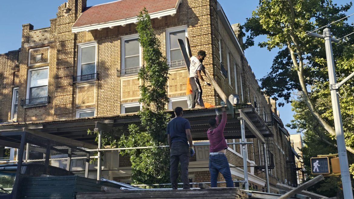 Technician repairing parapet damage, safeguarding your building from leaks and ensuring its strength and safety.