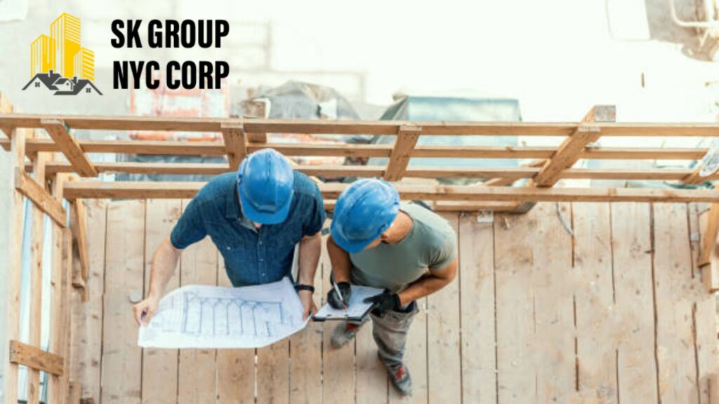 Two contractors reviewing balcony construction plans on-site, SK Group NYC Corp offering balcony remodeling and design ideas for 2026.