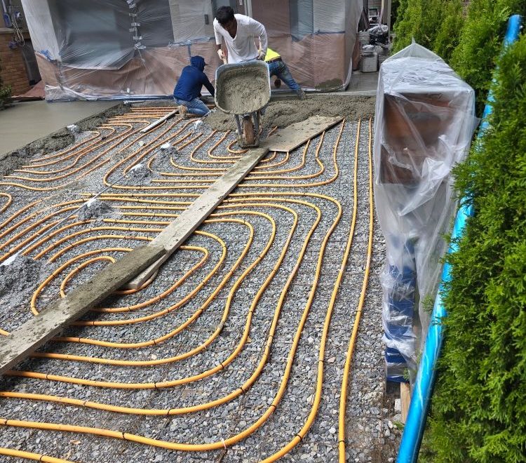 A heated driveway installation showing heating cables being laid beneath concrete, ensuring a snow-free surface for winter.