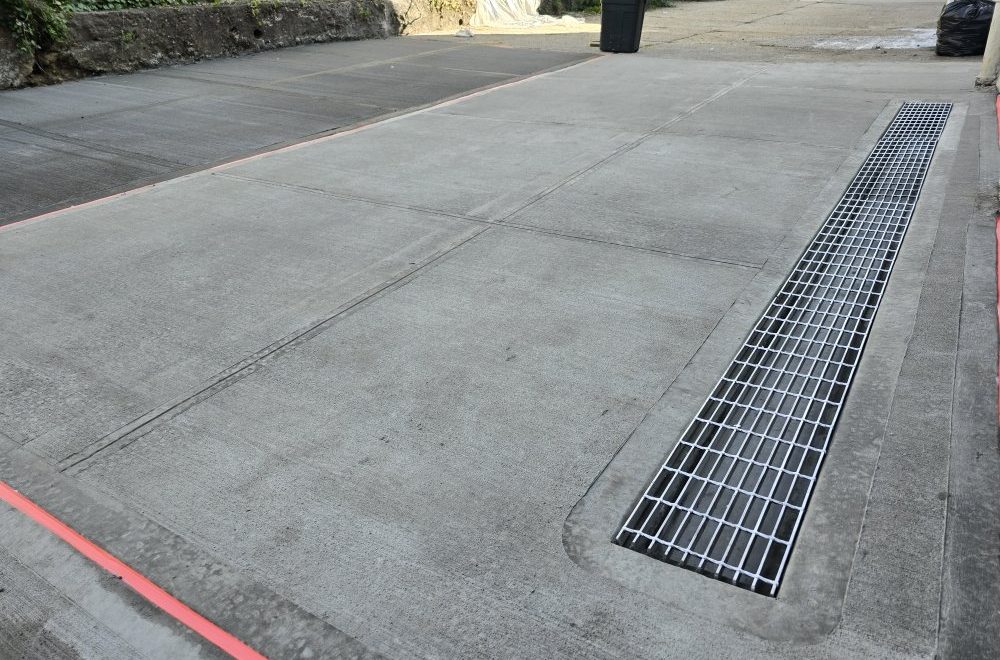 Zip Drain System installed in a driveway, effectively managing water flow and preventing pooling or damage.