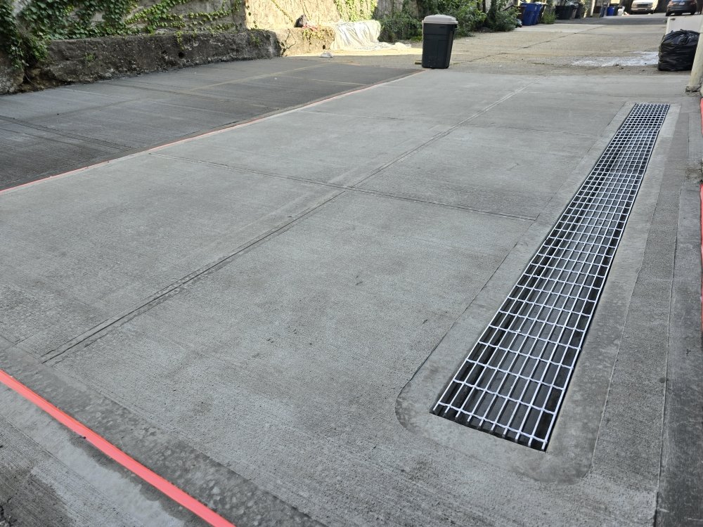 Zip Drain System installed in a driveway, effectively managing water flow and preventing pooling or damage.