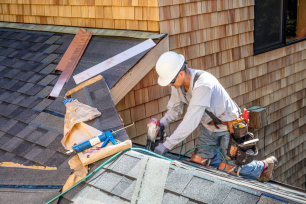 Roofing professional installing the best asphalt shingles on a sloped house roof with tools and safety gear.