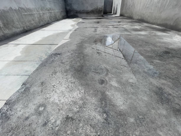 water puddle on a damp concrete basement floor