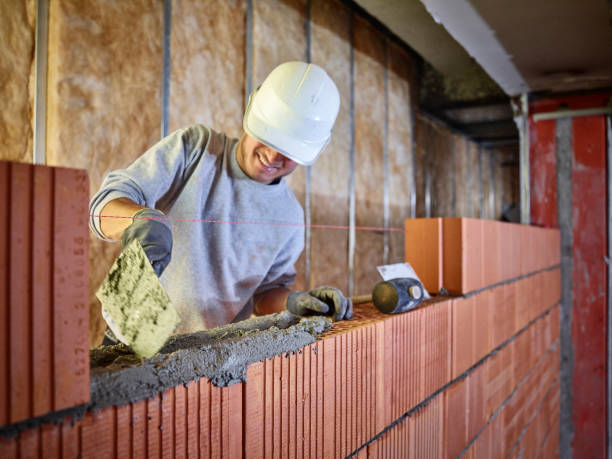 Brick mason repairing NYC wall