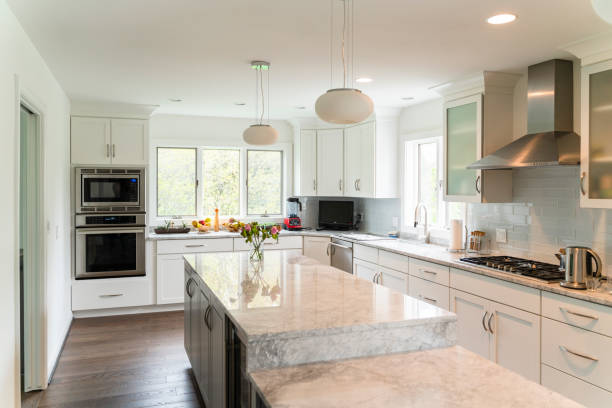 Modern NYC kitchen with white cabinets, natural light, and minimalist design