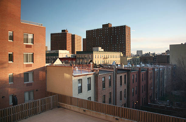 NYC brownstones with red roofs showing ideal house color schemes for a red roof in an urban residential neighborhood