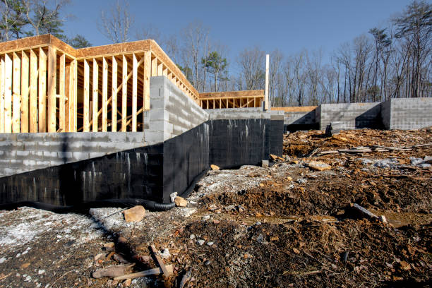New home foundation with black waterproof coating applied for crawl space and basement protection.