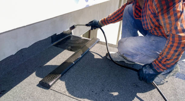 Waterproof roof coating applied by contractor on flat roof in NYC.