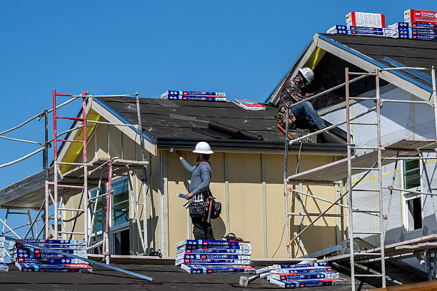 Contractors installing asphalt shingle roof in NYC – affordable roofing choice.
