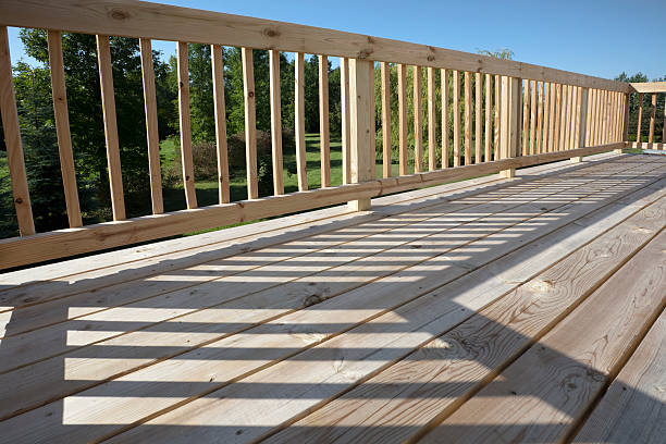 Custom wood deck in NYC with modern railing design built by SK Group NYC Corp.