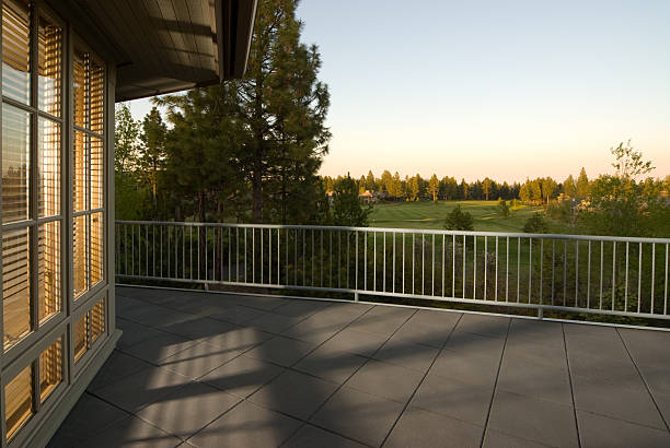 Modern deck railings installed on a spacious outdoor patio overlooking a scenic landscape