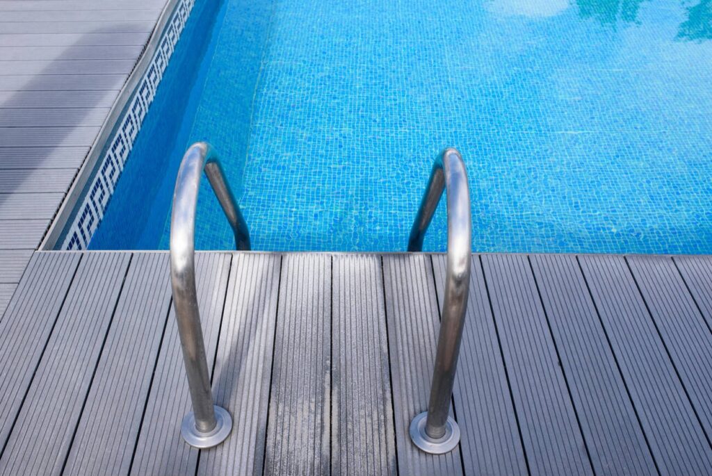 Modern poolside with durable metal decking and stainless steel railing showcasing high-quality metal deck design in NYC.