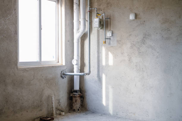 Installing a sump pump in a basement to prevent water damage