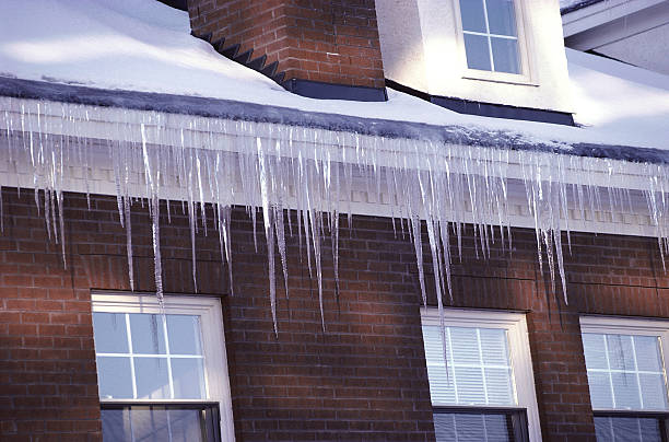 Ice dam forming on residential roof during winter