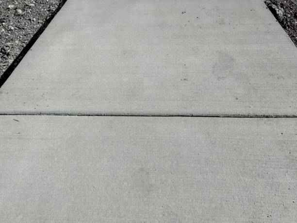 NYC sidewalk repair contractor fixing damaged sidewalk panels for residential property