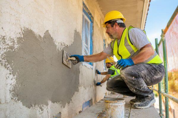 Professional stucco repair services restoring damaged exterior walls in NYC.